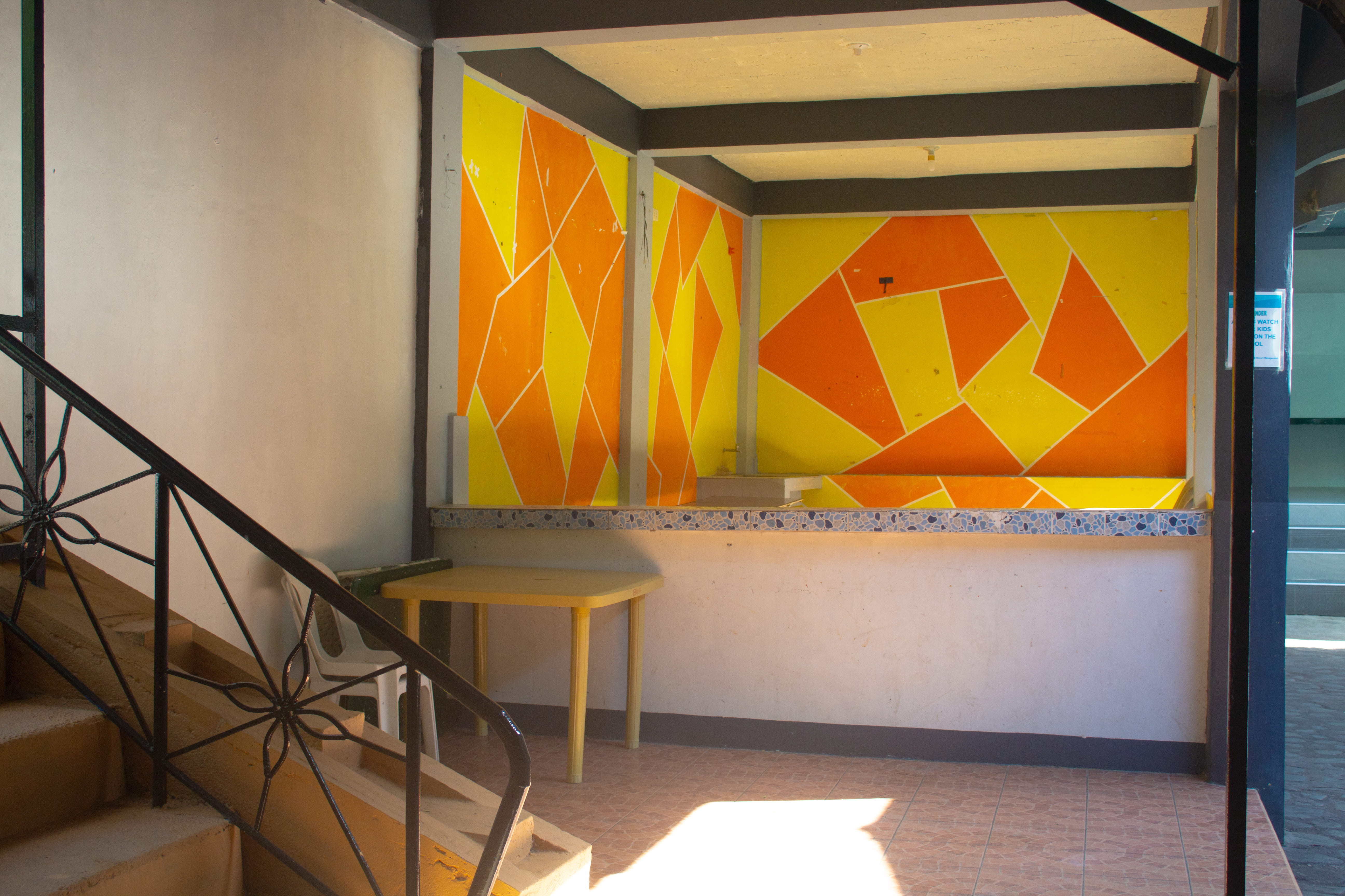 A VIP cottage with a forest-inspired design, featuring wooden-style benches and a white table in a cozy setting.